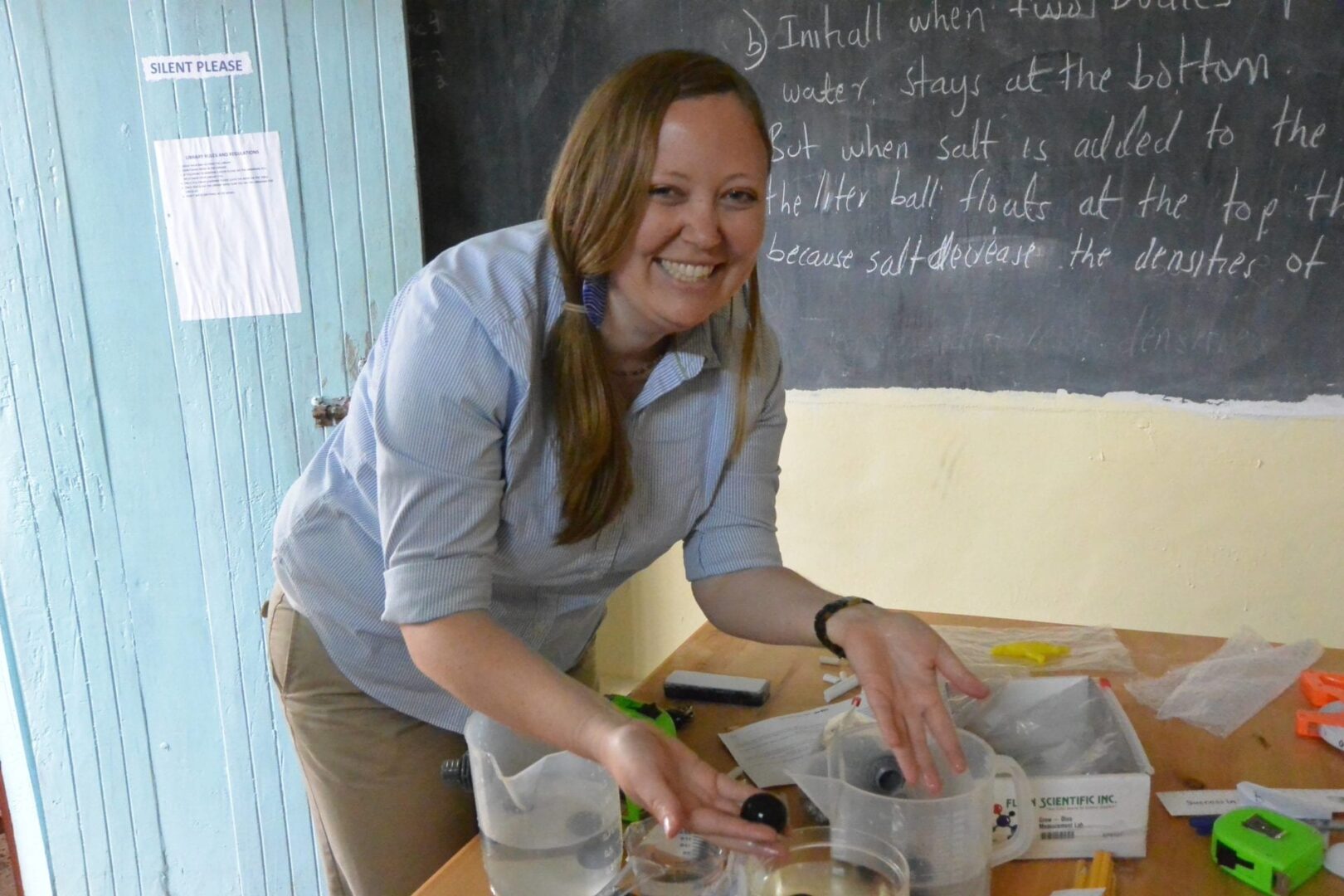 A woman standing in front of a chalkboard.