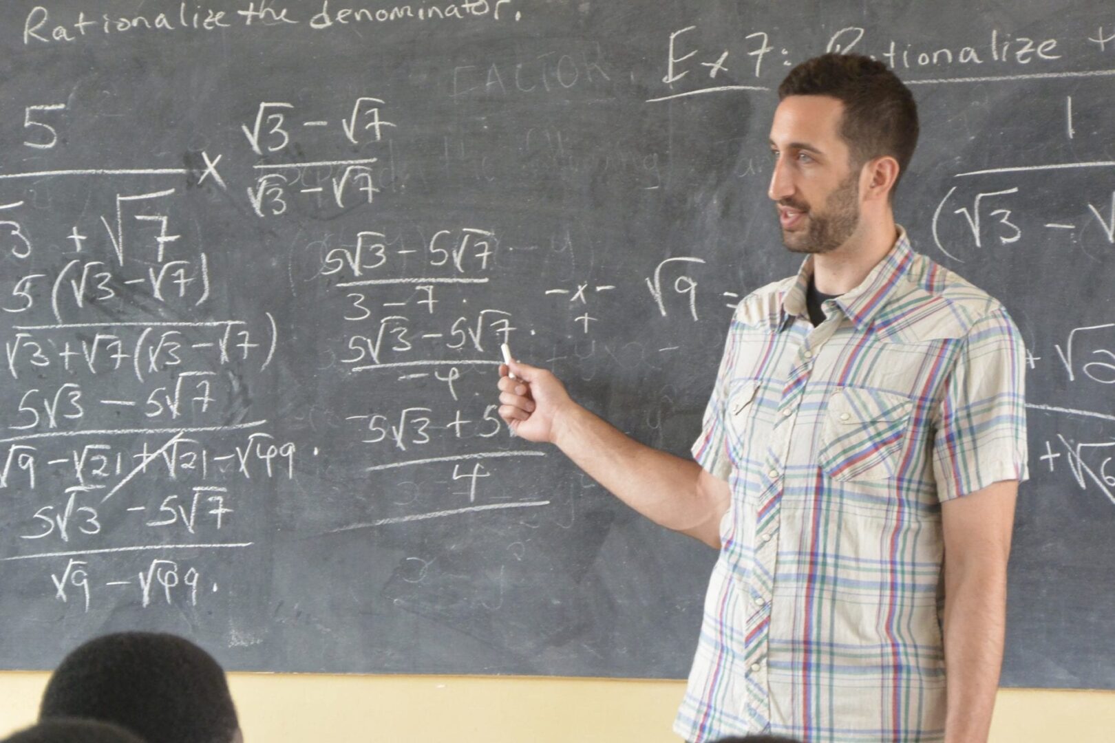 A man standing in front of a chalkboard.