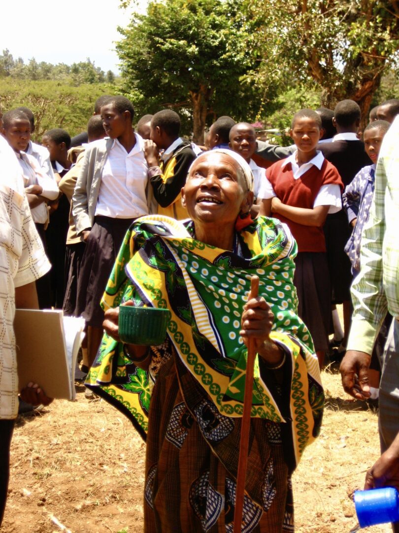 A woman in traditional clothing is smiling for the camera.