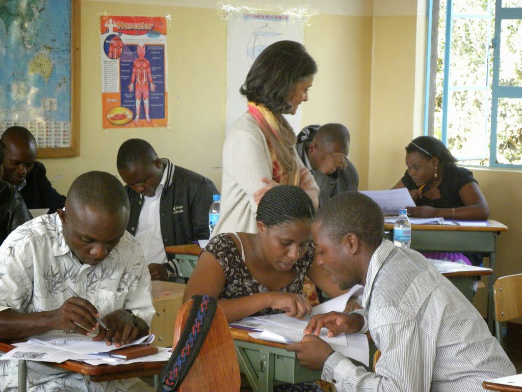 A group of people sitting at tables with papers.