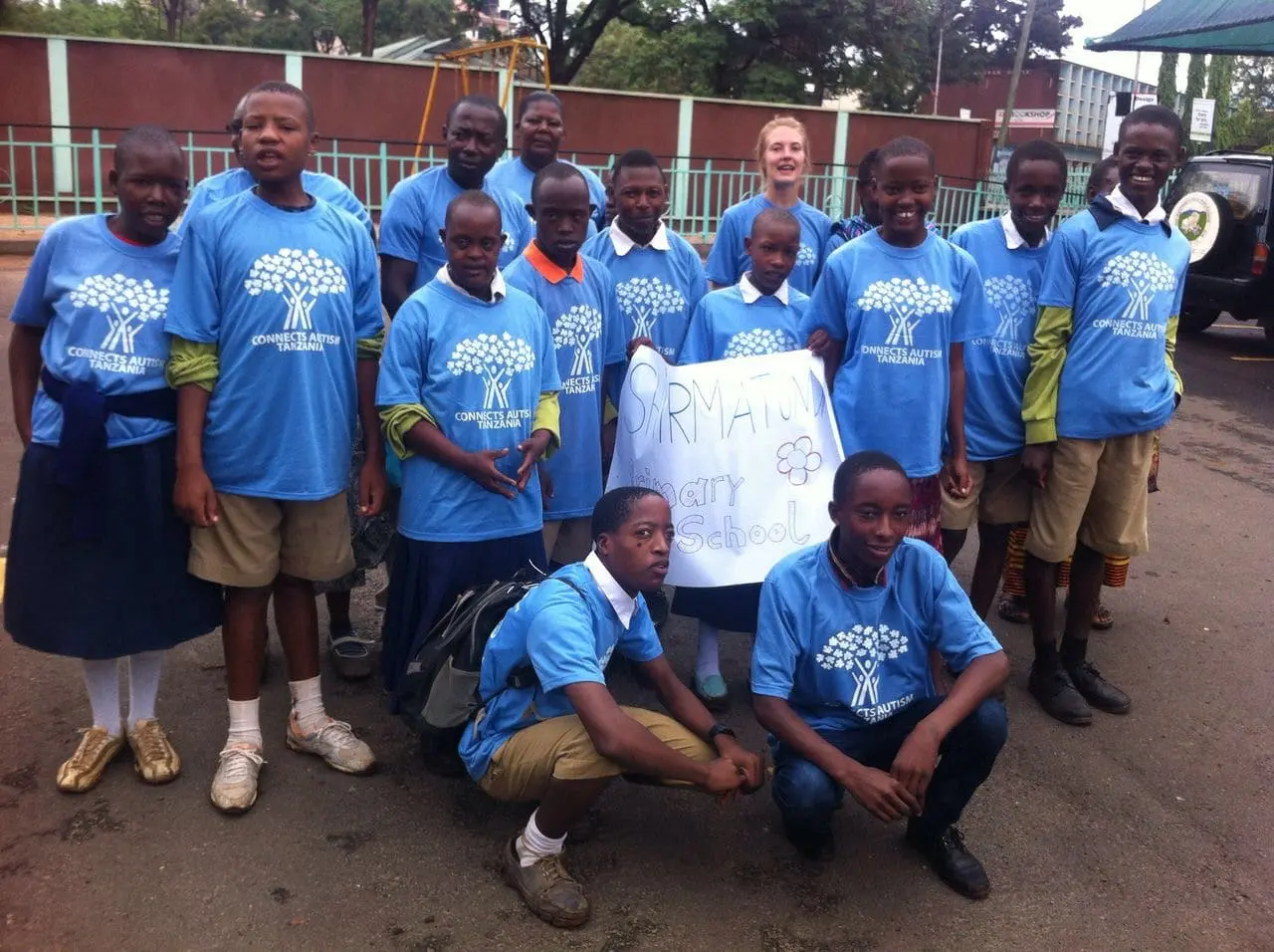 A group of people in blue shirts and shorts.