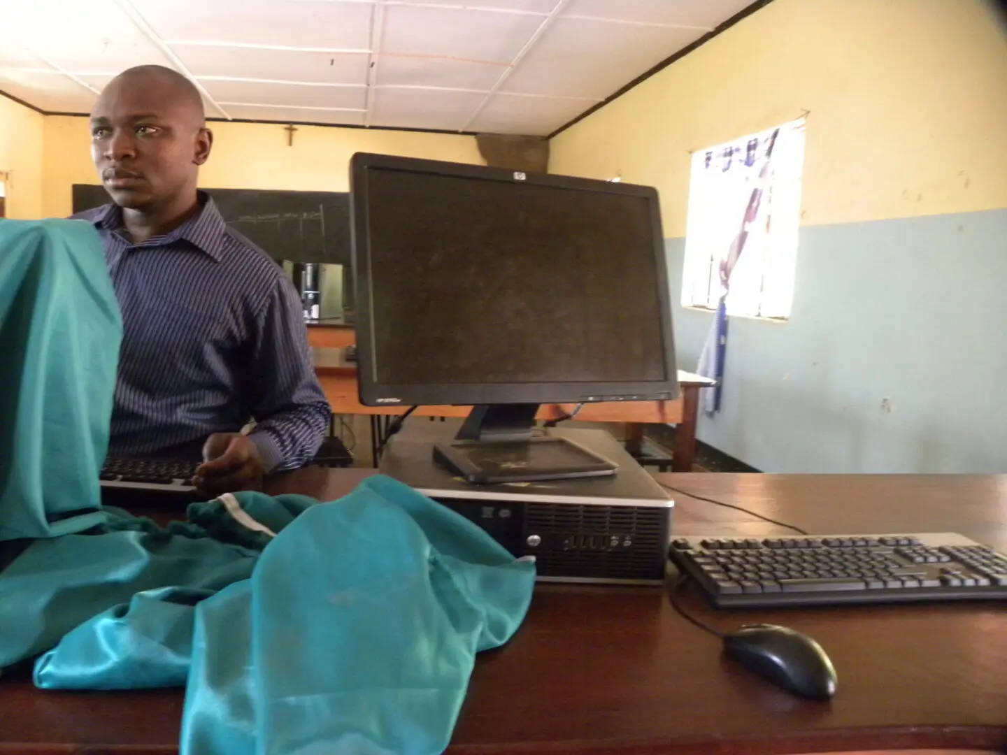 A man sitting at his computer desk with a laptop.