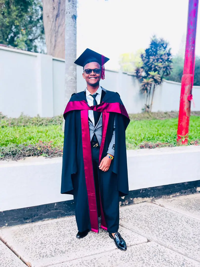 A man in a graduation cap and gown.