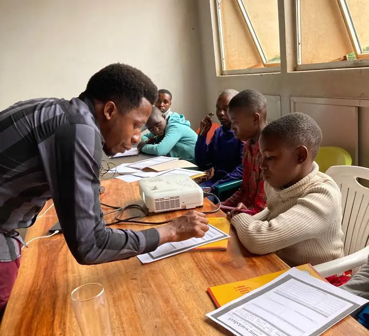 Teacher helping students with their work.