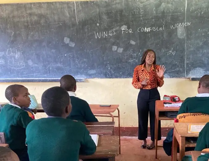 Teacher speaking to students in classroom.