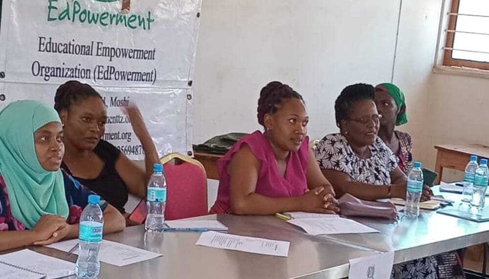 Women at a meeting table with papers.