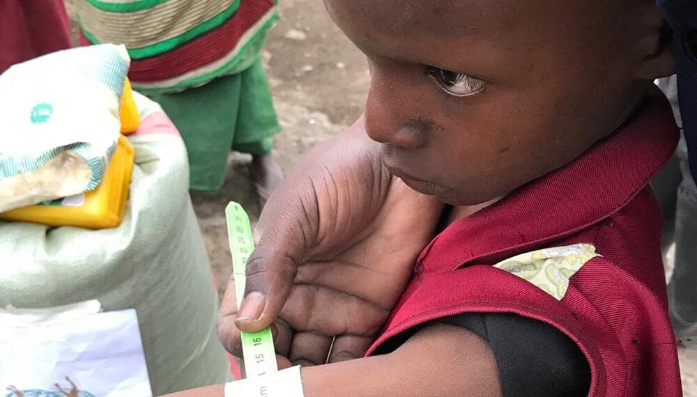 Child's arm measured with a tape.