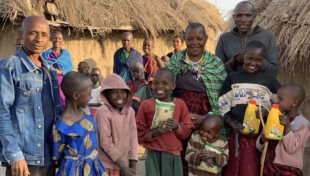 Group of people smiling in rural setting.