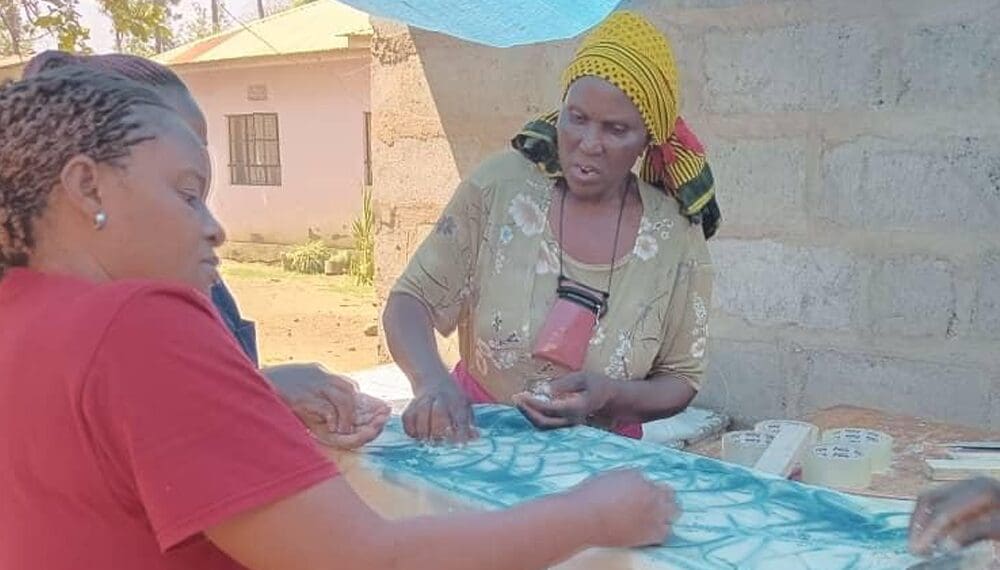 Women working together on fabric design.
