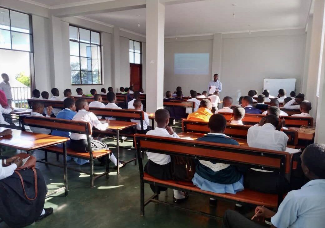 A classroom full of students sitting at desks.