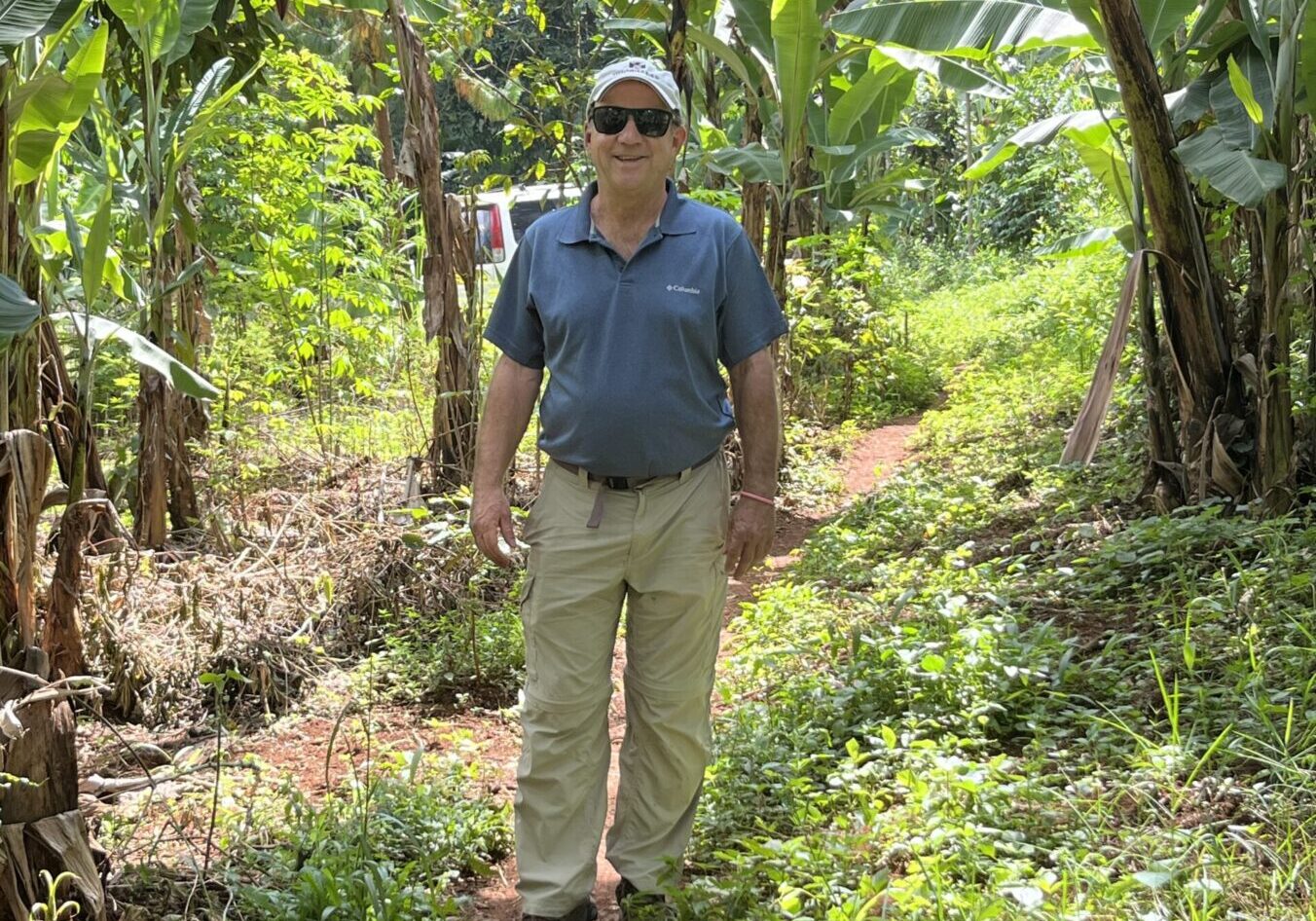 Man smiling in a banana plantation.